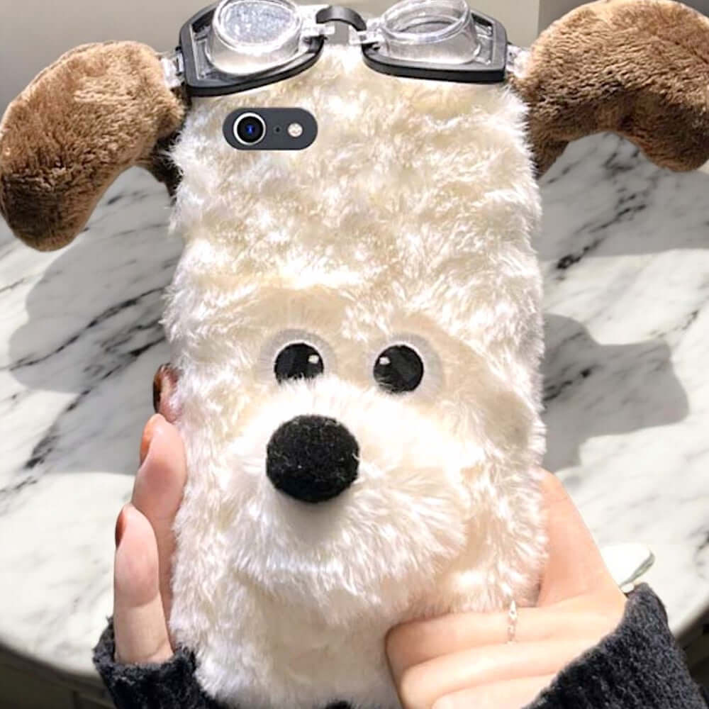 a person holding a stuffed dog wearing glasses