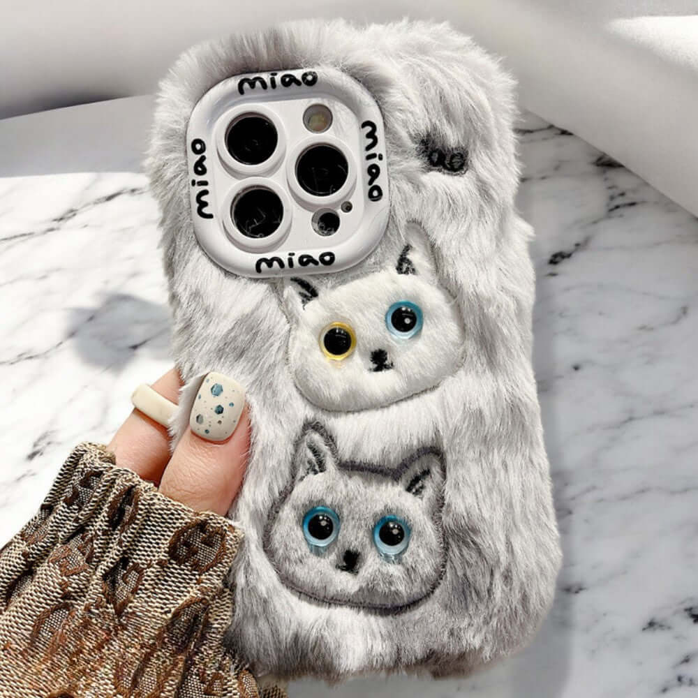 a person holding a phone case with cats on it