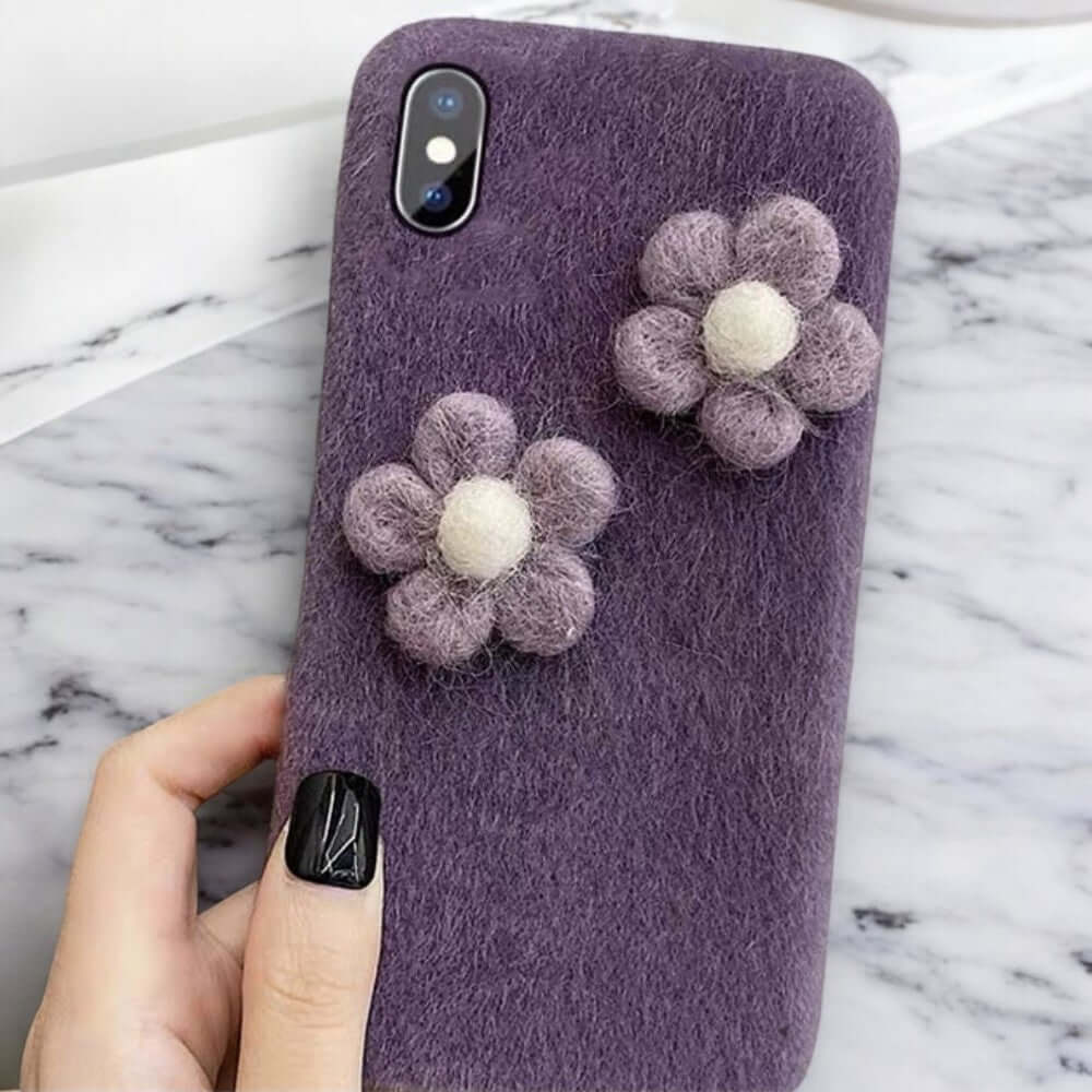 a person holding a phone case with flowers on it