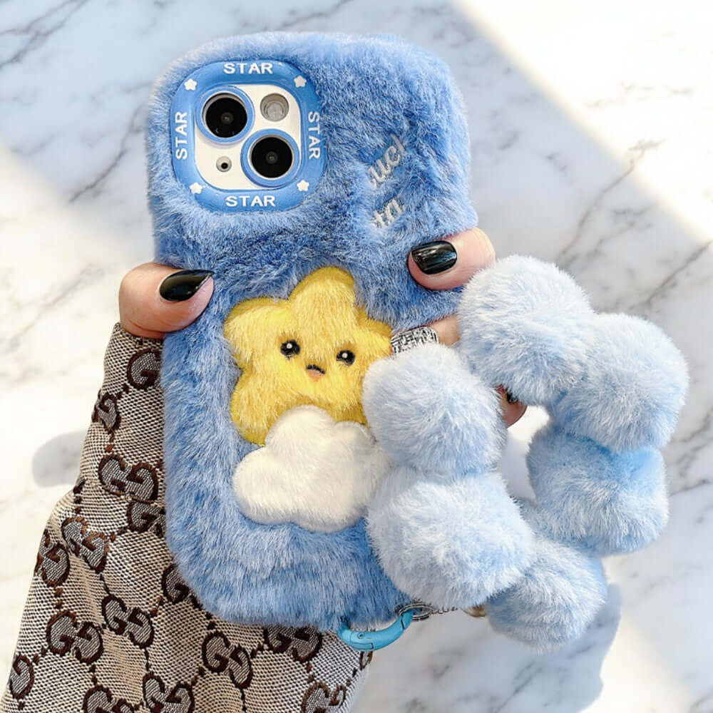 a person holding a cell phone with a stuffed animal on it