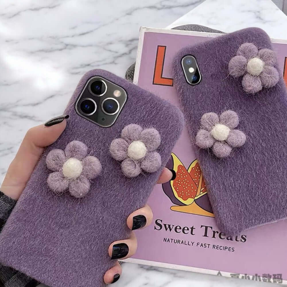 a person holding a purple phone case with flowers on it