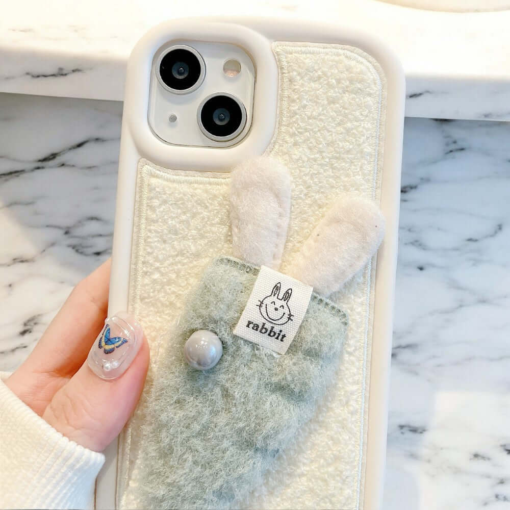 a person holding a phone case with a bunny on it