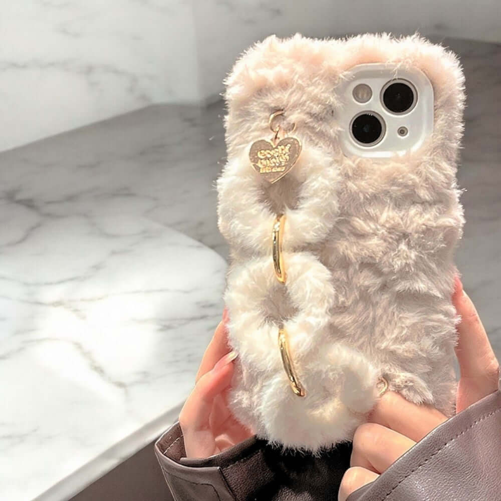 a person holding a white teddy bear in their hand