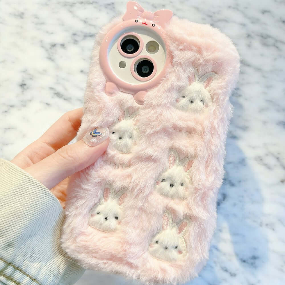 a person holding a pink phone case with cats on it