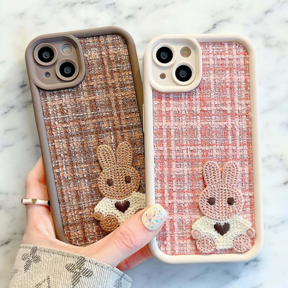 a person holding a phone case with a bunny and a rabbit on it