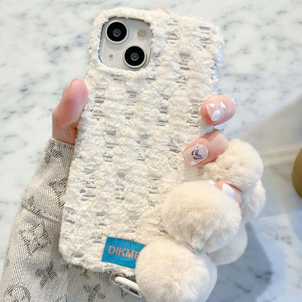 a person holding a phone case with a teddy bear on it