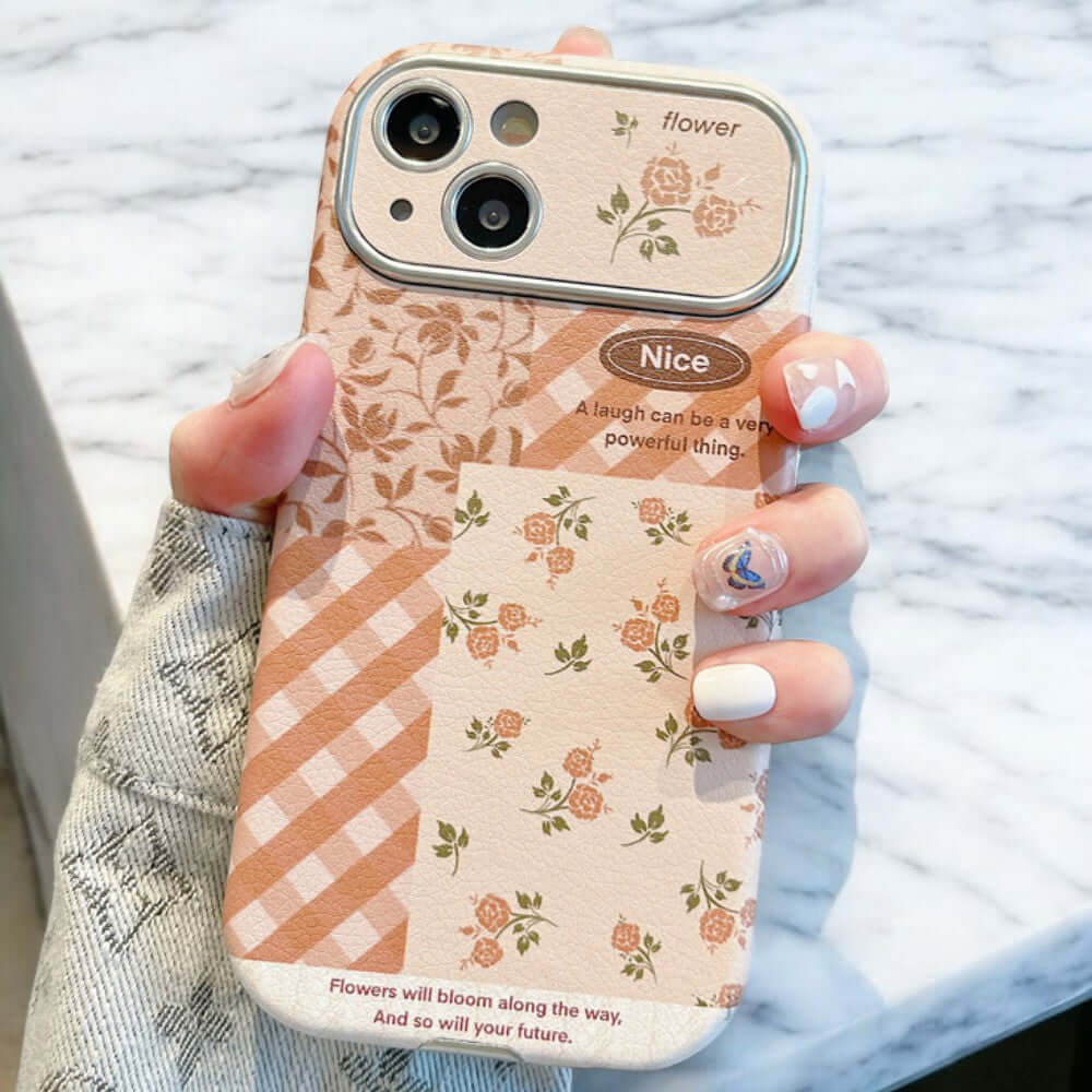 a woman holding a phone case with flowers on it