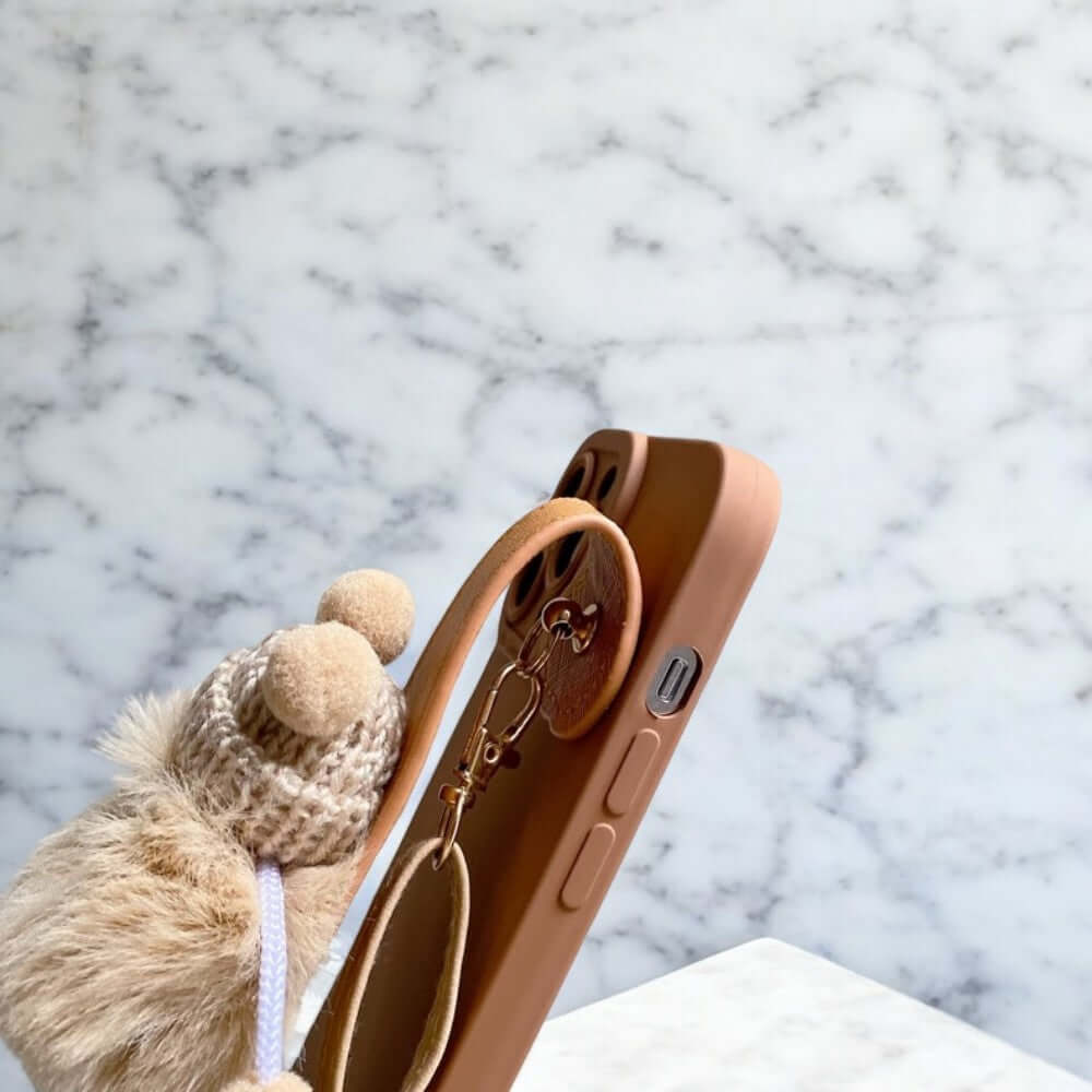 a teddy bear sitting on top of a piece of luggage