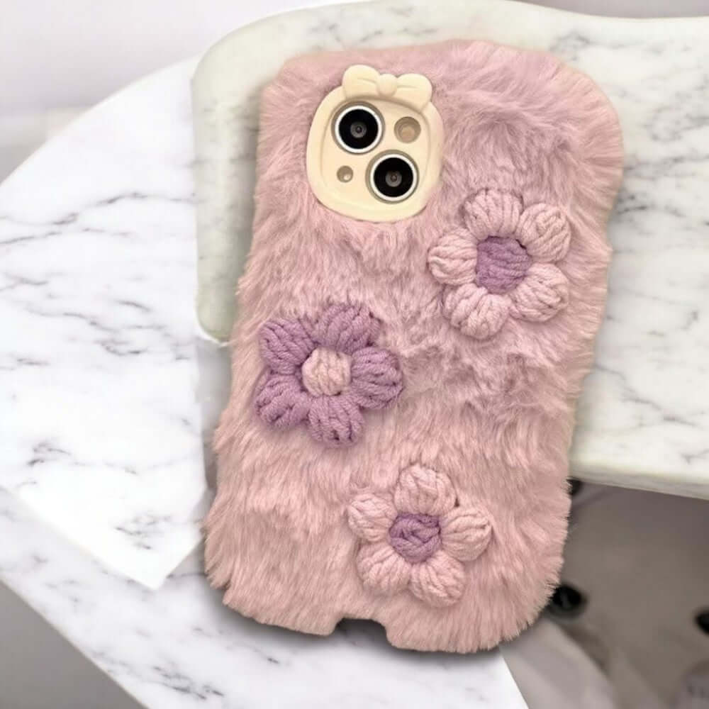 a pink phone case with flowers on it