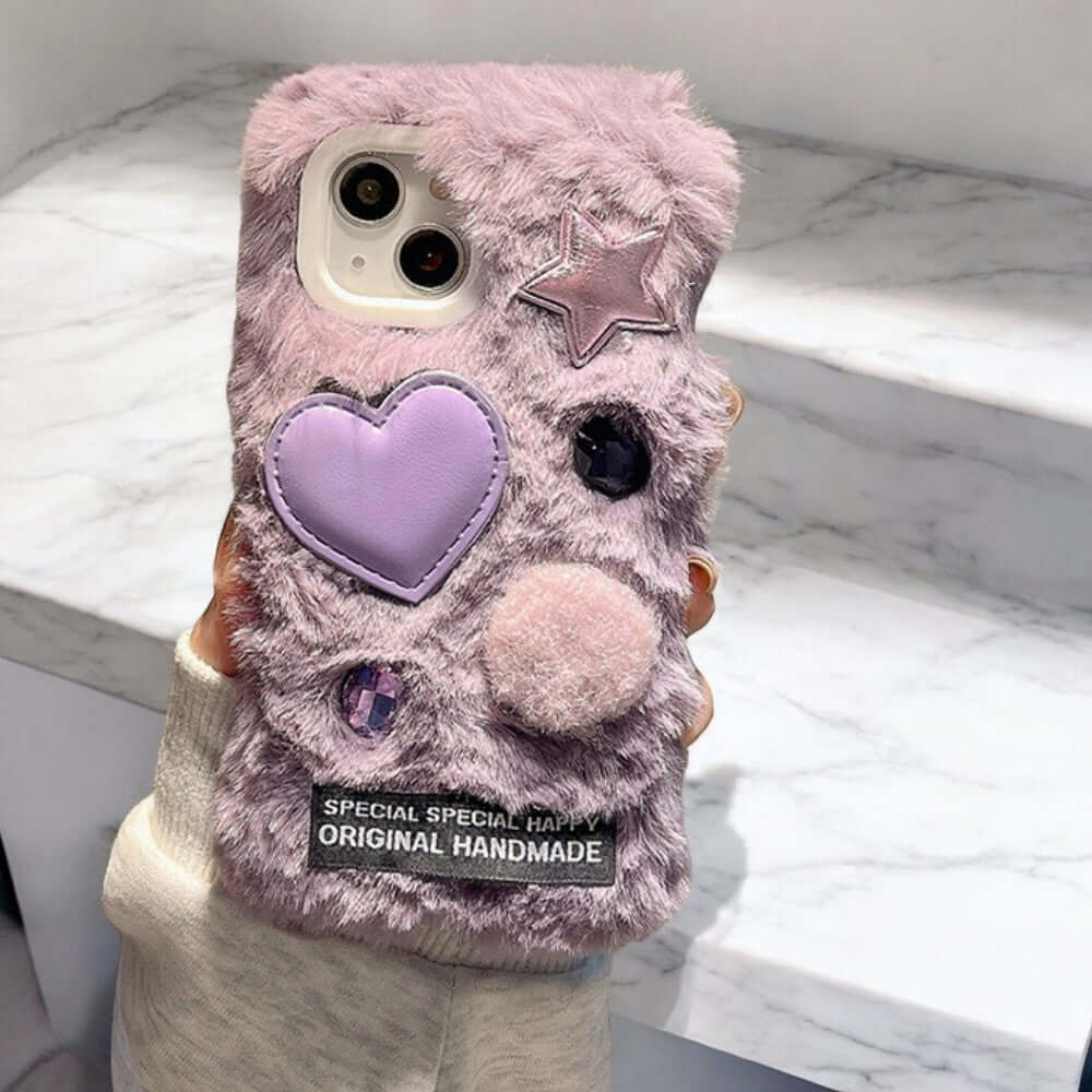 a person holding a cell phone case with a heart on it