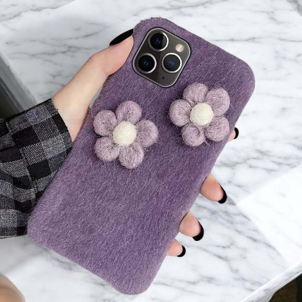 a person holding a phone case with flowers on it