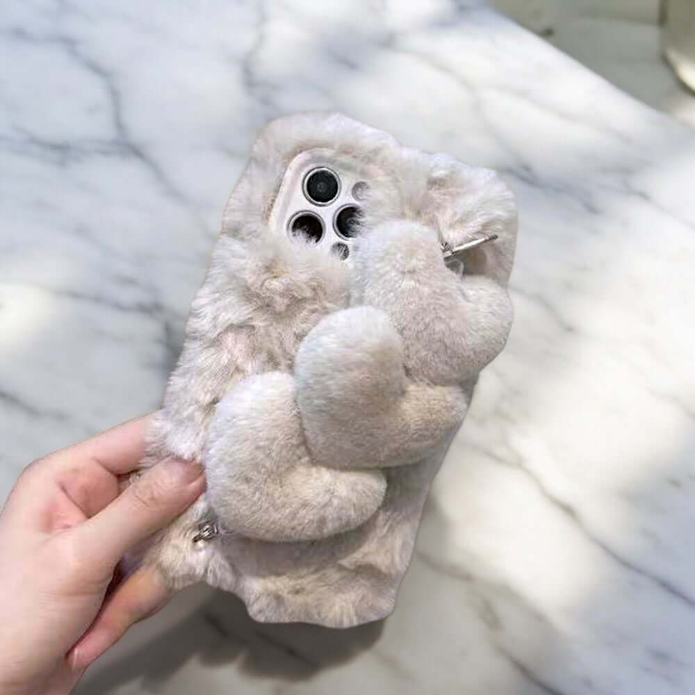 a person holding a cell phone case with a teddy bear on it