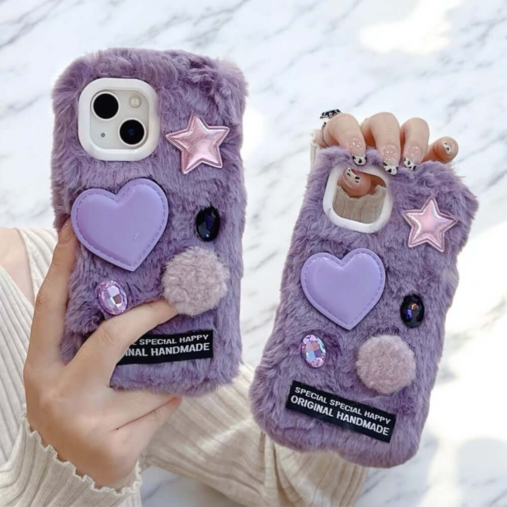 a person holding a purple phone case with a heart and star on it