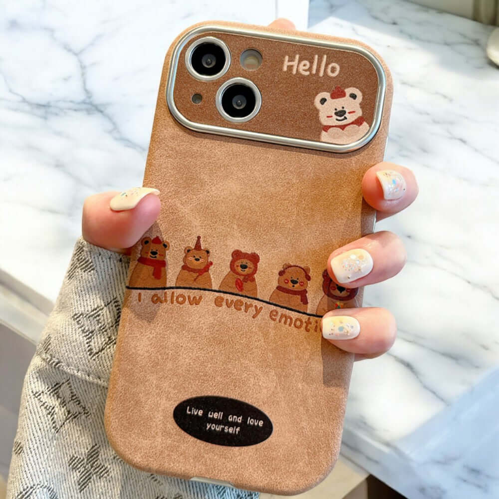 a woman holding a cell phone case with a picture of a bear on it