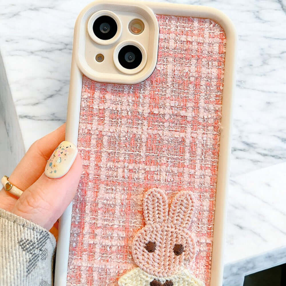 a person holding a phone case with a bunny on it