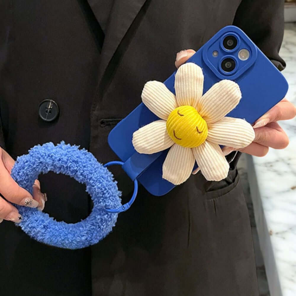 a person holding a phone case with a flower on it