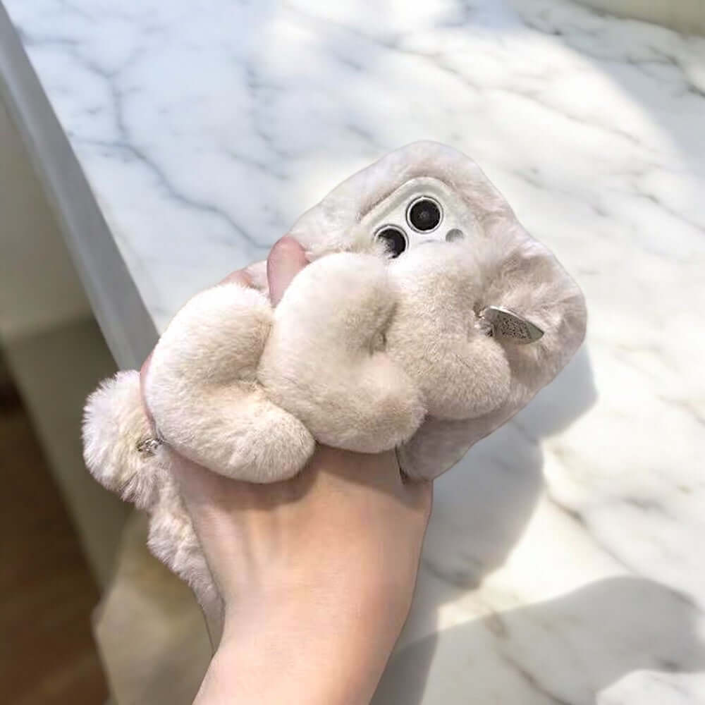 a person holding a stuffed animal in their hand